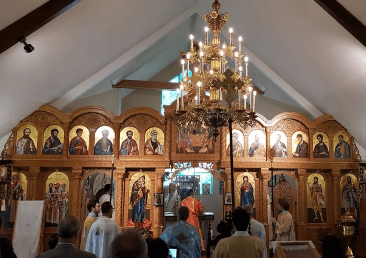 The faithful standing at the Divine Liturgy before the iconostasis at Holy Three Hierarchs